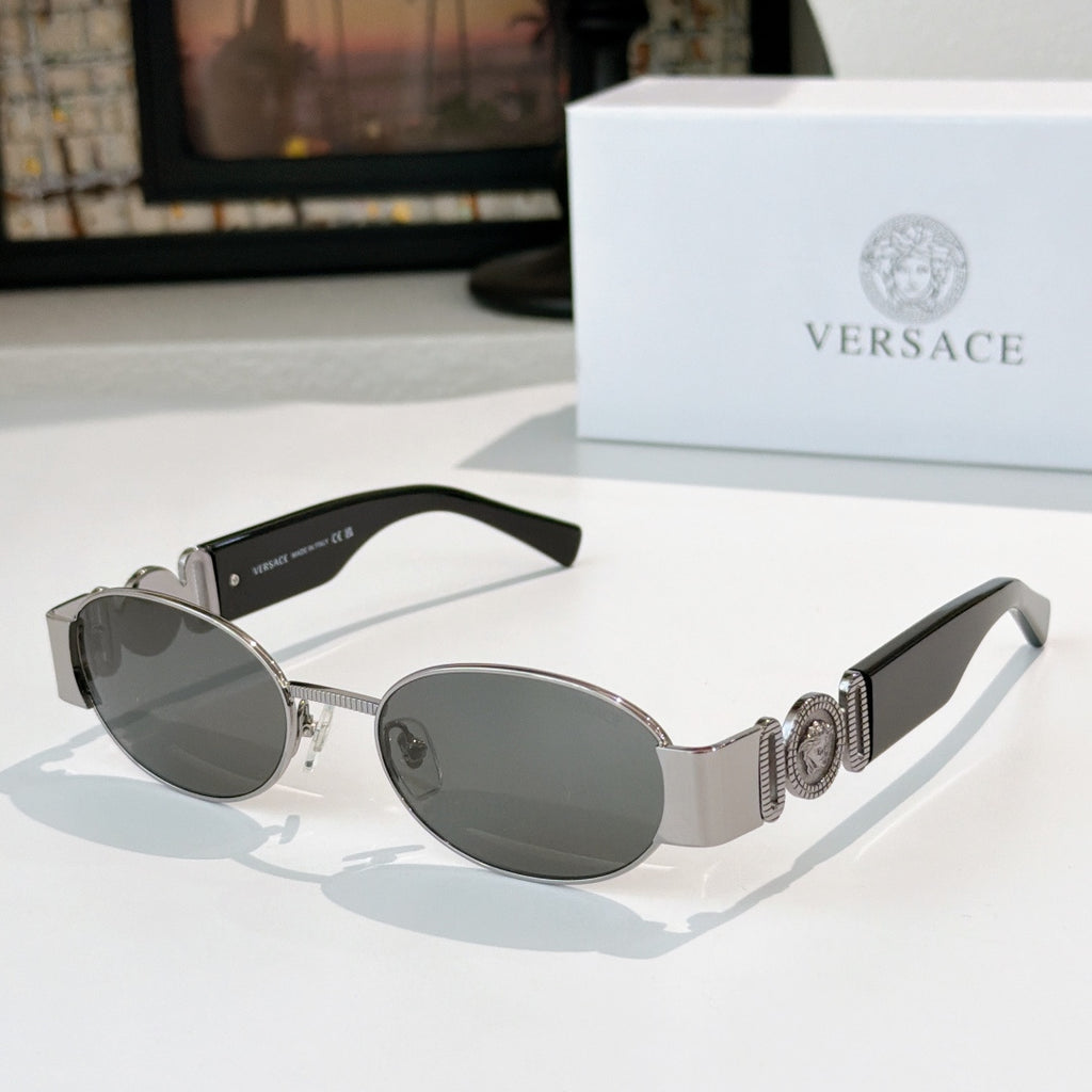 Versace sunglasses: silver frame, dark oval lenses, patterned temple detail.