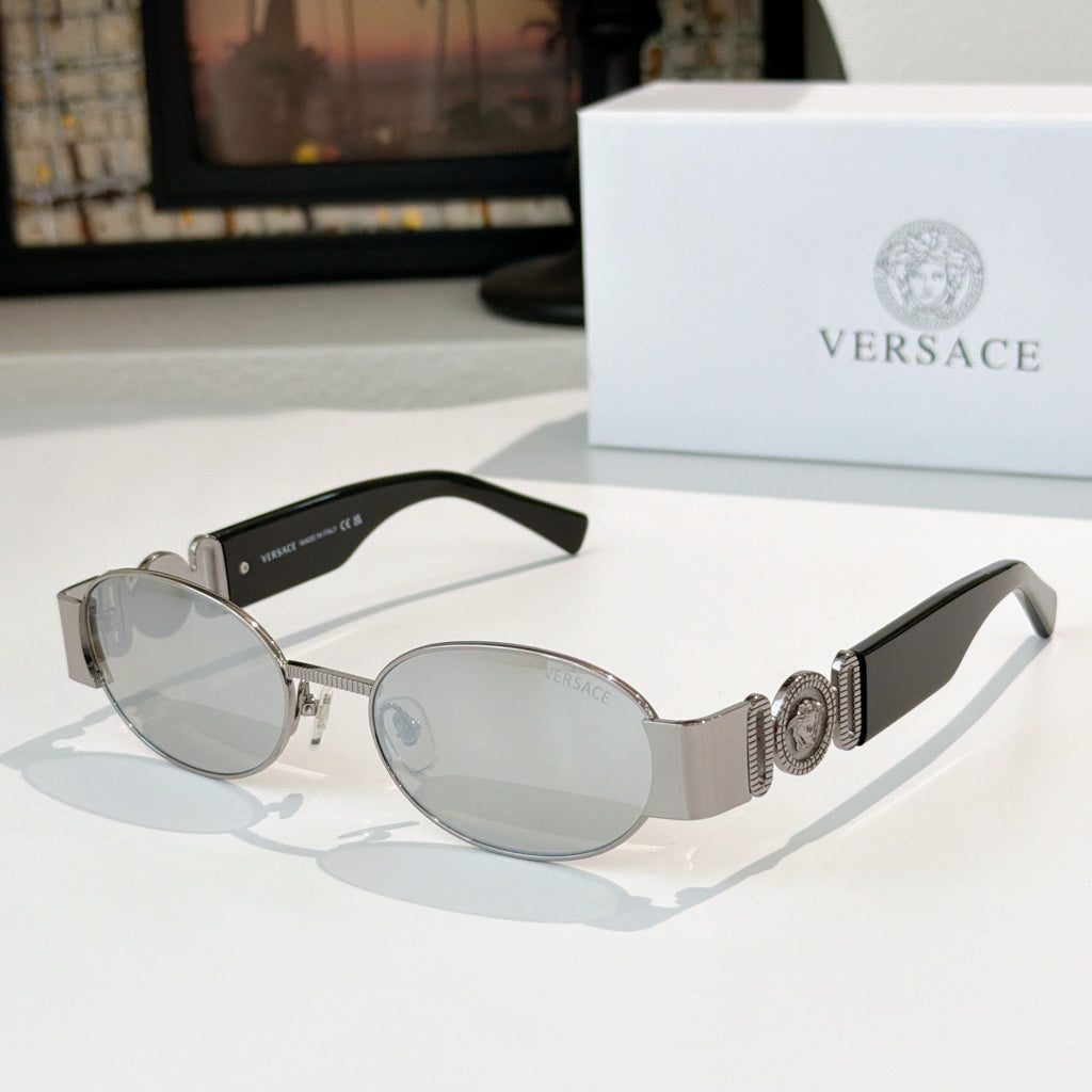 Versace sunglasses: silver frame, gray-tinted oval lenses, patterned temples.