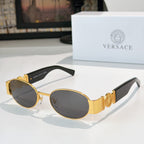 Versace sunglasses: gold frame, dark oval lenses, black temple tips.