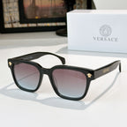 Black cat-eye sunglasses with pink tinted lenses and gold logo hinge