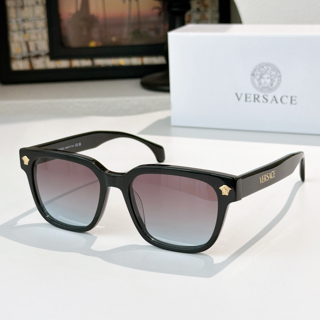 Black cat-eye sunglasses with pink tinted lenses and gold logo hinge