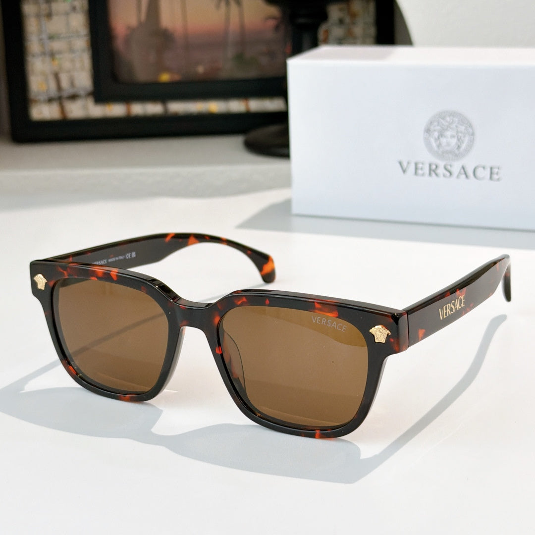 Tortoise sunglasses with amber-brown lenses and gold logo details