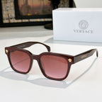 Maroon sunglasses with mauve tinted lenses and gold logo hinges