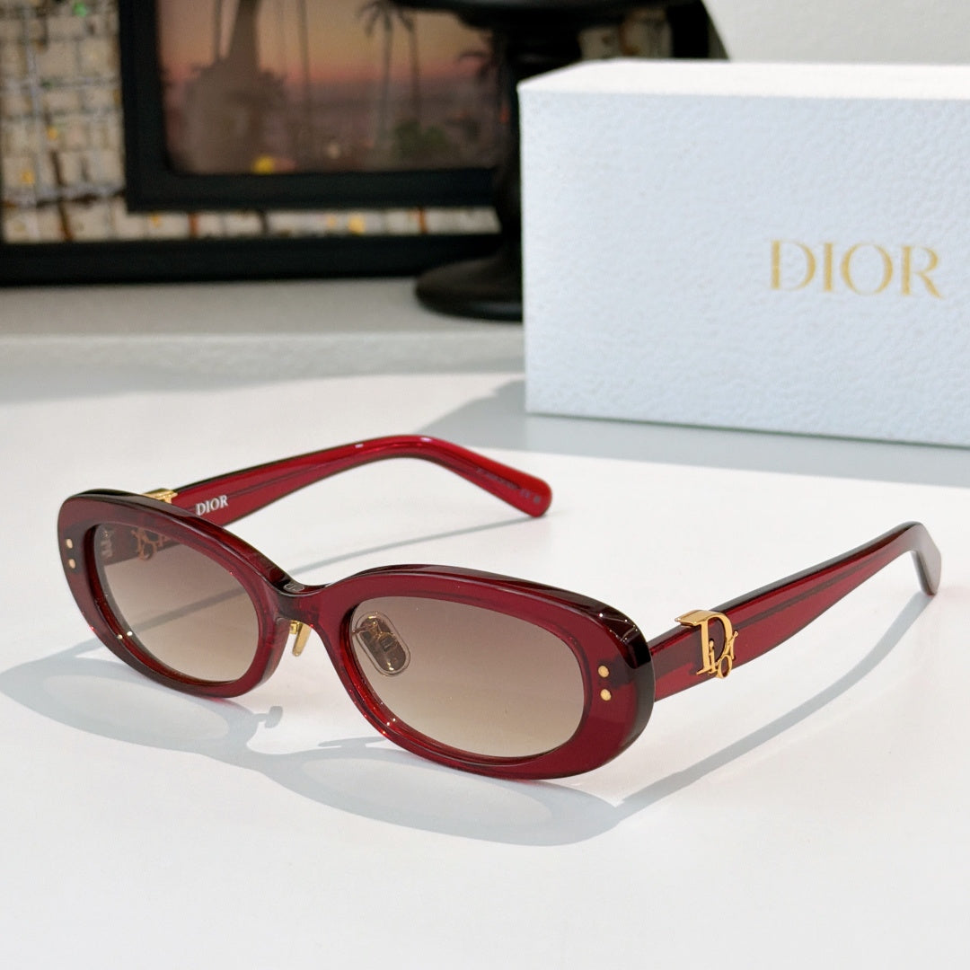 Dior oval sunglasses with red frames, brown lenses, and gold D-logo side accents