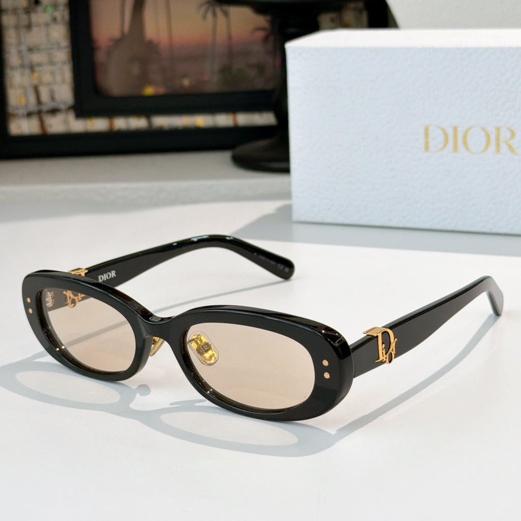 Dior oval sunglasses with black frames, dark lenses, and gold D-logo side detail