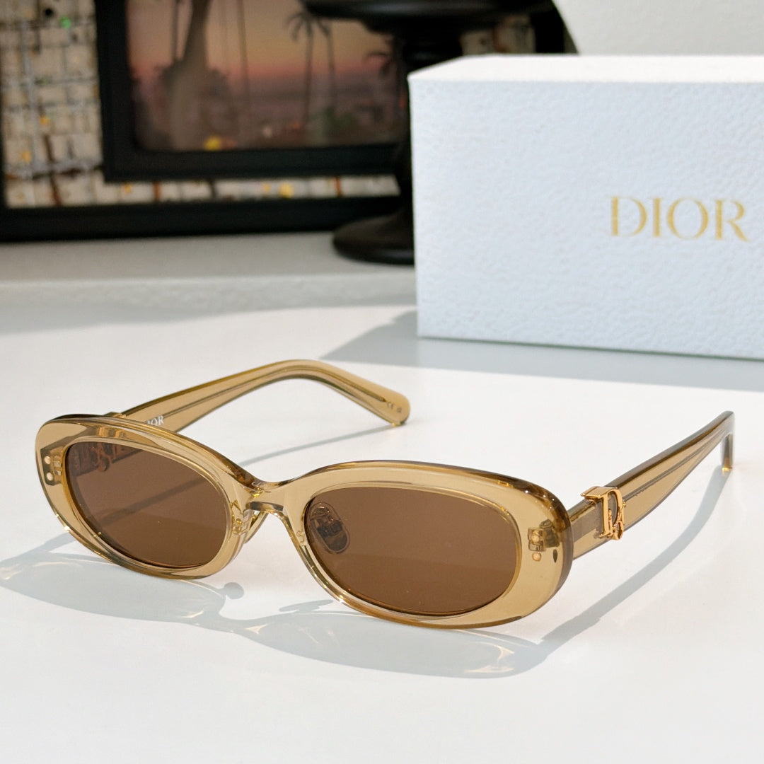 Dior oval sunglasses with gold frames, brown lenses, and gold D-logo side details