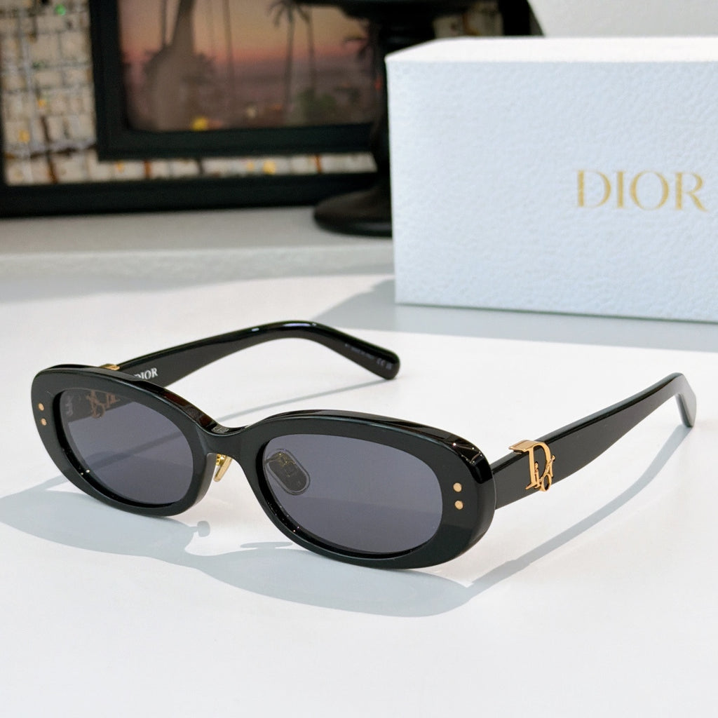 Dior oval sunglasses with black frames, dark lenses, and gold D-logo side accents