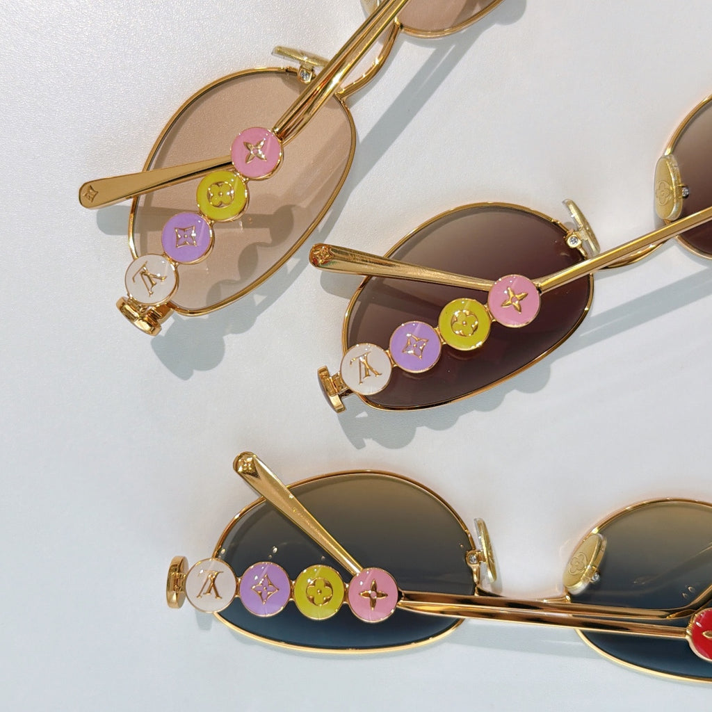 Louis Vuitton sunglasses with gold frame and multicolor logo charms on temple