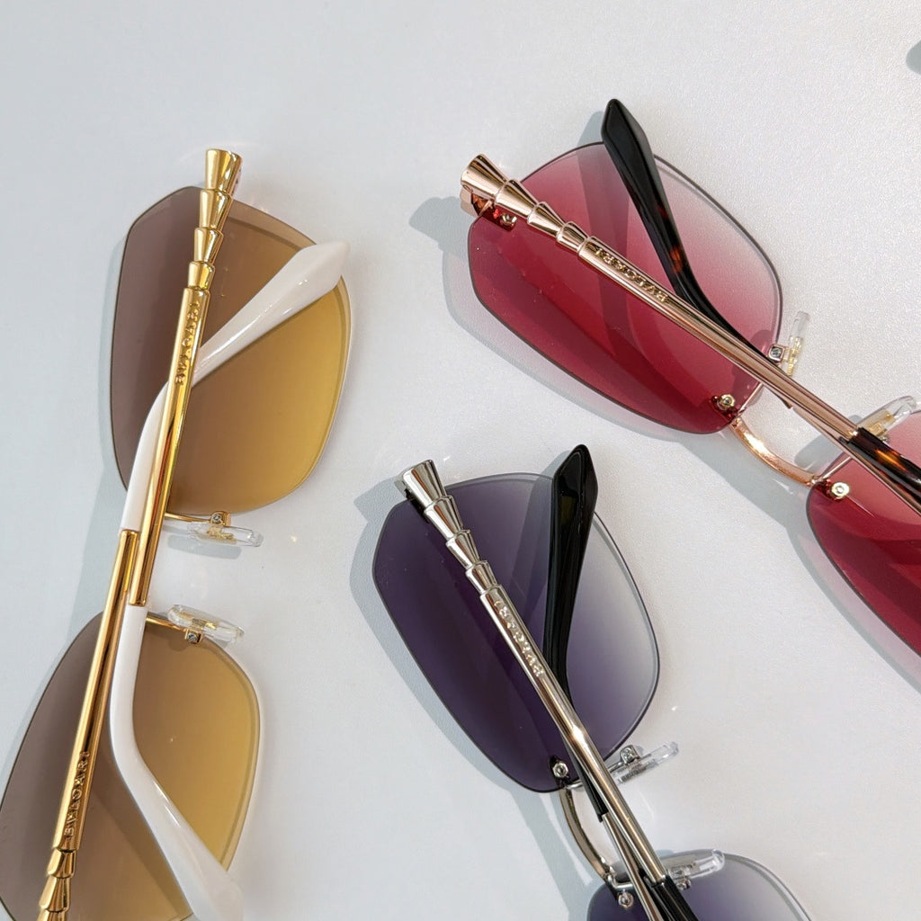 Assorted sunglasses set with gold-tone frames and colored lenses in red, amber, and purple