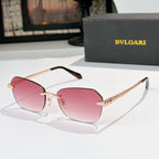 Fashion sunglasses with gold-tone frame and pink tinted lenses, sculpted temple details
