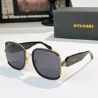 Bvlgari sunglasses with black frames, gold accents, and dark tinted lenses