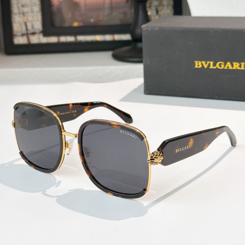 Bvlgari sunglasses with black frames, gold accents, and dark tinted lenses