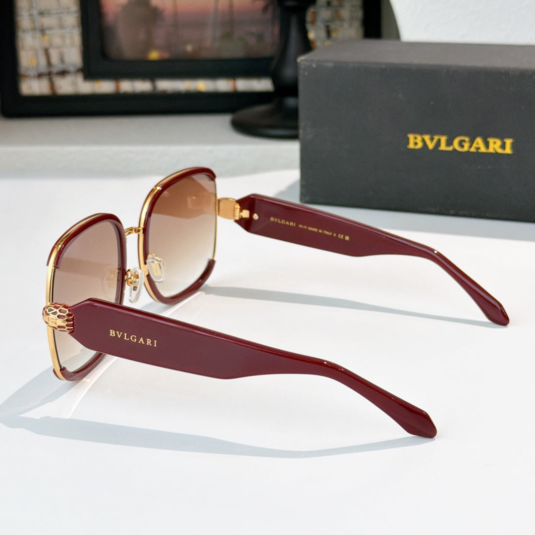 Bvlgari sunglasses with maroon frames, gold accents, and amber tinted lenses