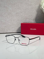 Black eyeglasses with clear lenses and red logo bar on the temple