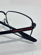 Black eyeglasses with red-and-blue logo bar on temple and clear lenses