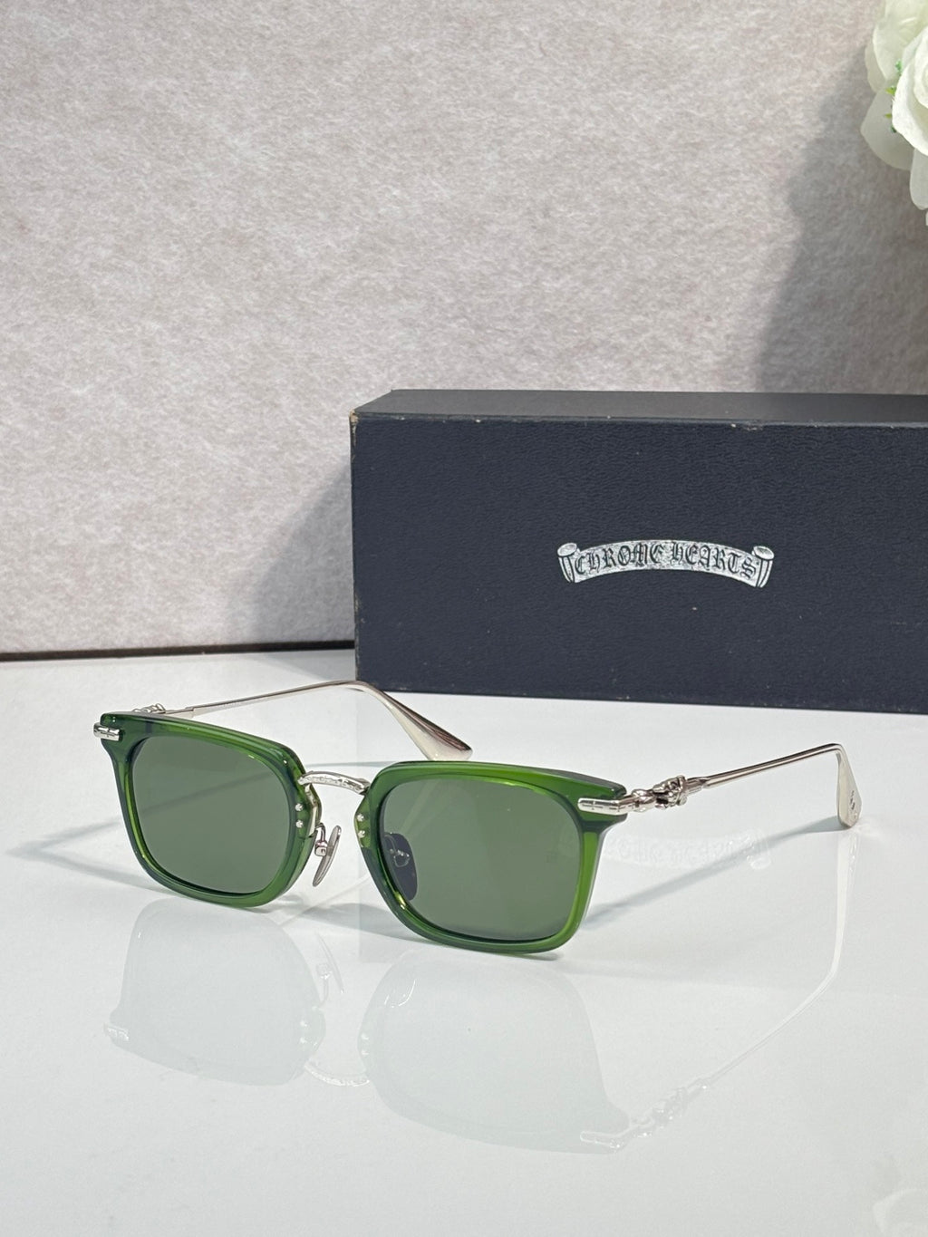 Green-tinted square eyeglasses with metal frame and clear protective lens area