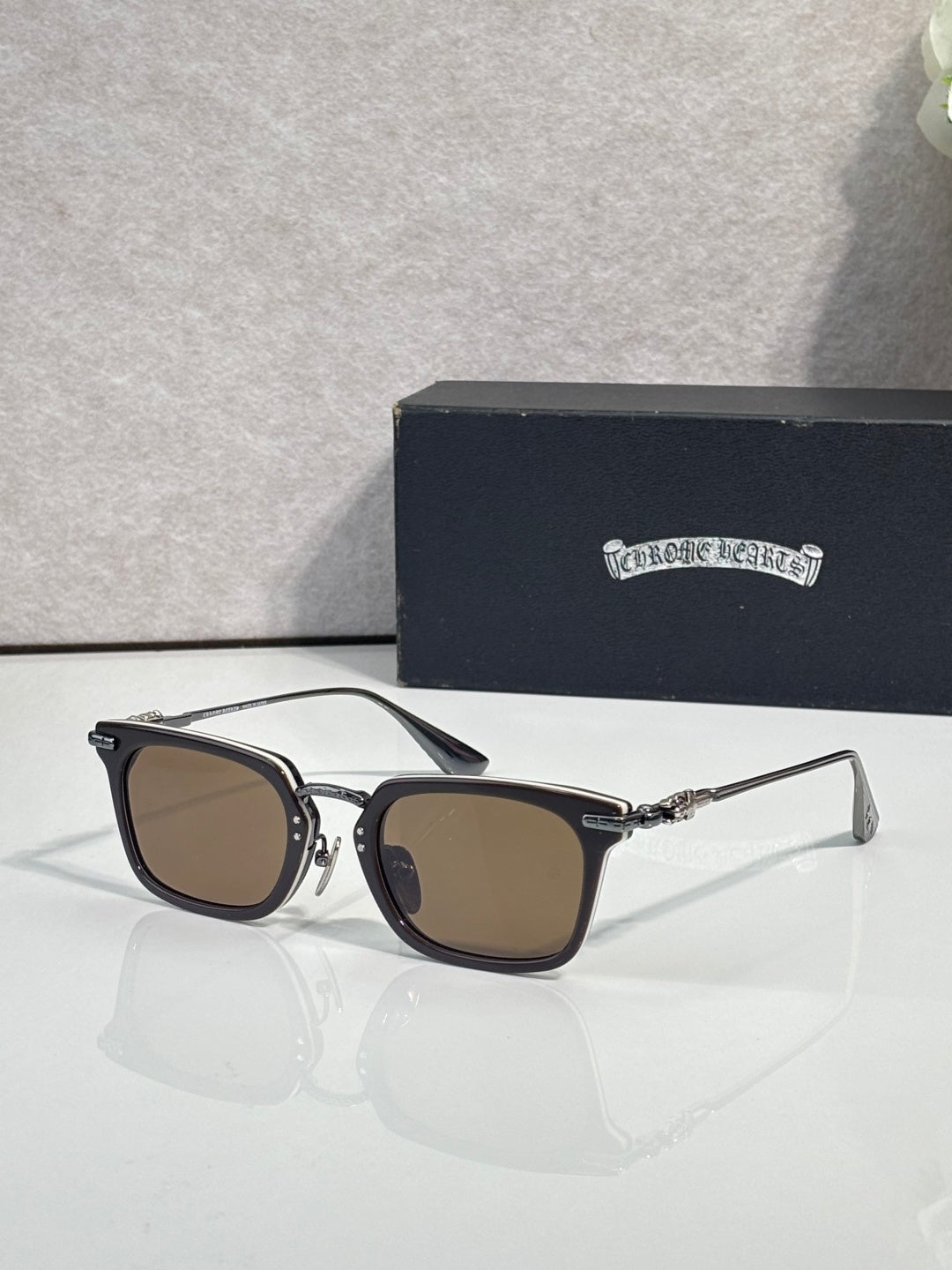 Brown-tinted square eyeglasses with dark frame and silver-tone metal temple accents