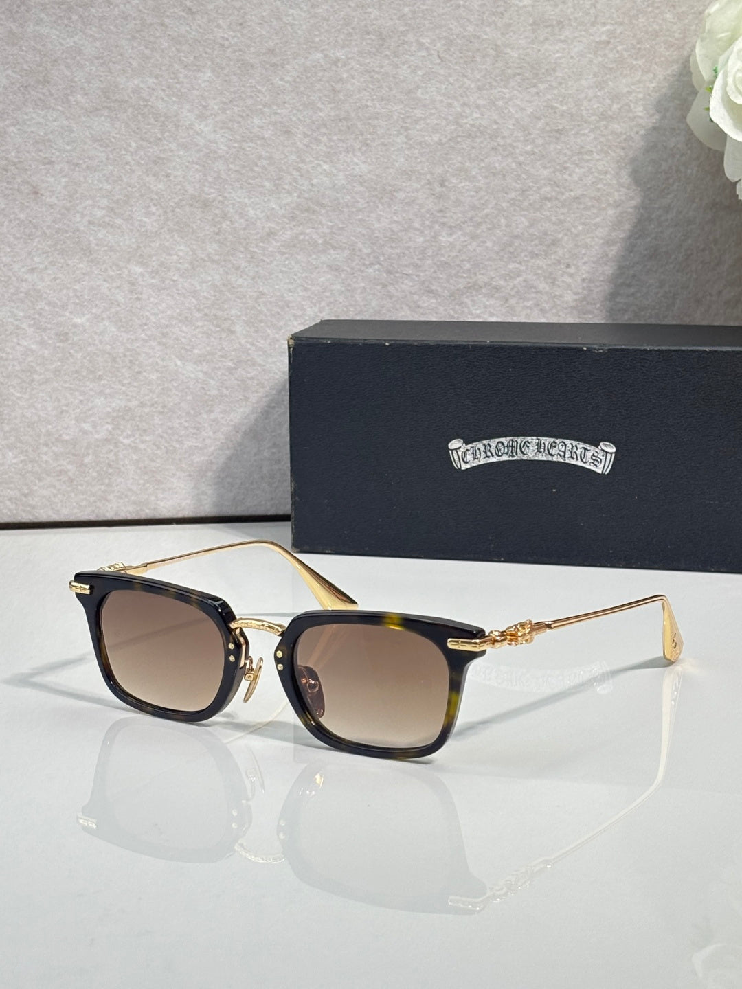 Brown-tinted square eyeglasses with dark frame and gold-tone metal temple accents