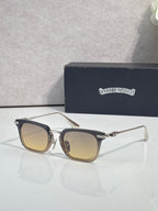 Amber-tinted square eyeglasses with dark frame and silver-tone metal temple details