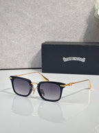 Smoke-tinted square eyeglasses with gold-tone frame and dark lenses