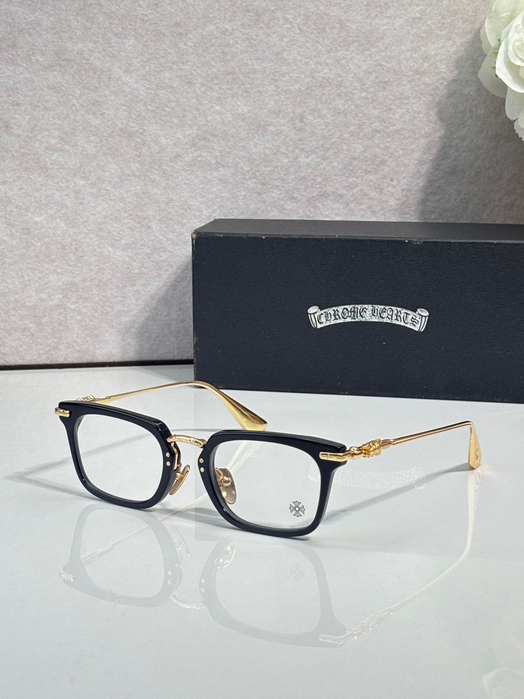 Chrome glasses with dark blue rectangular frames and clear lenses