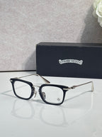 Chrome glasses with black rectangular frames and clear lenses, side view