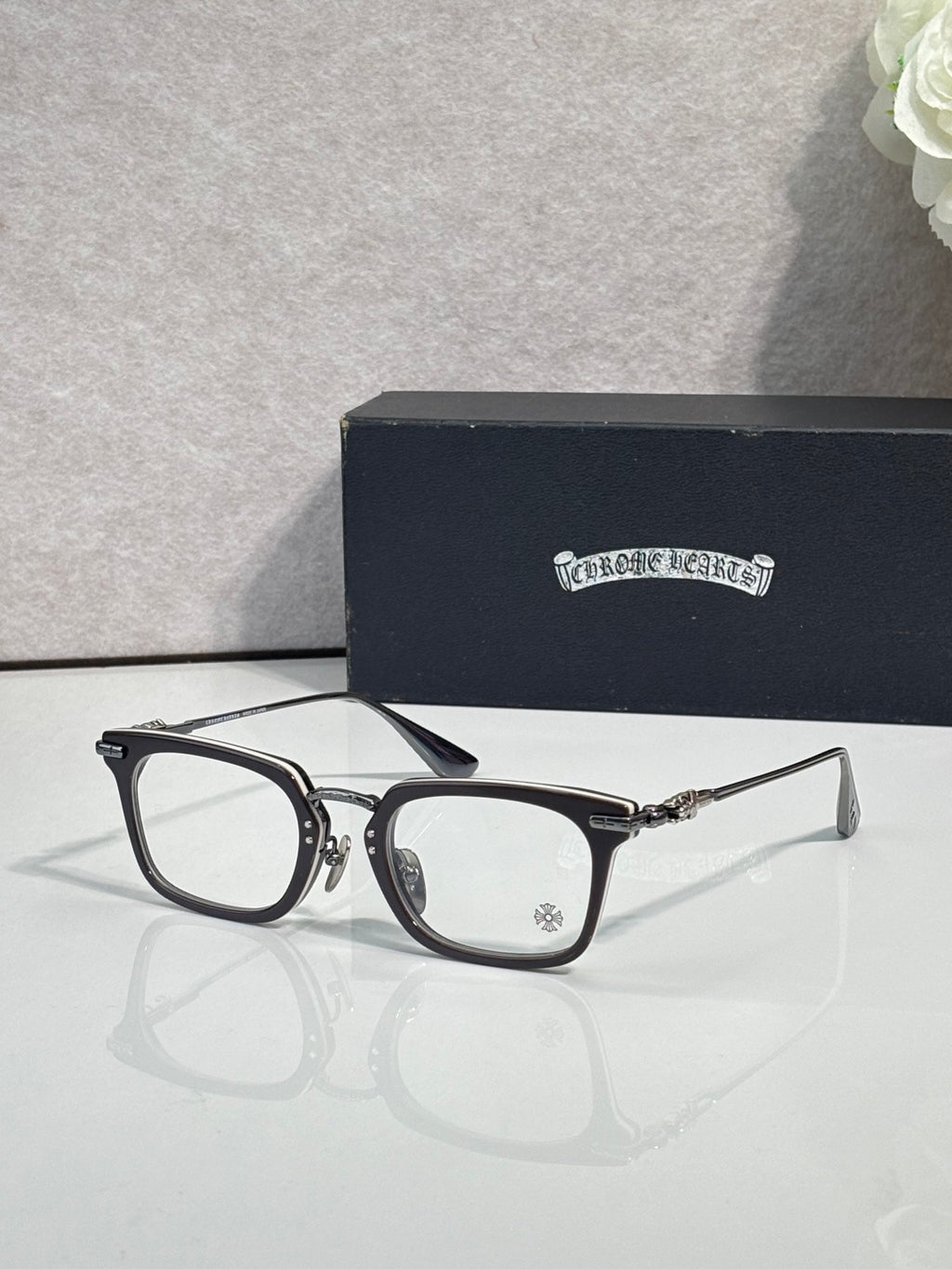 Chrome glasses with black rectangular frames and clear lenses
