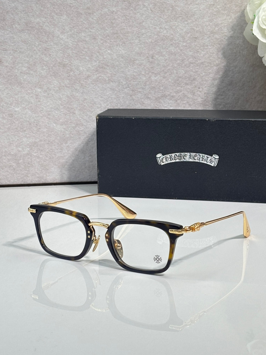 Chrome glasses with gold rectangular frames and clear lenses