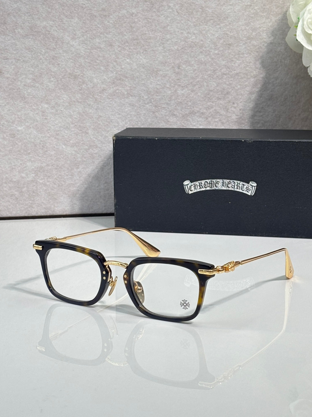 Chrome glasses with gold rectangular frames and clear lenses