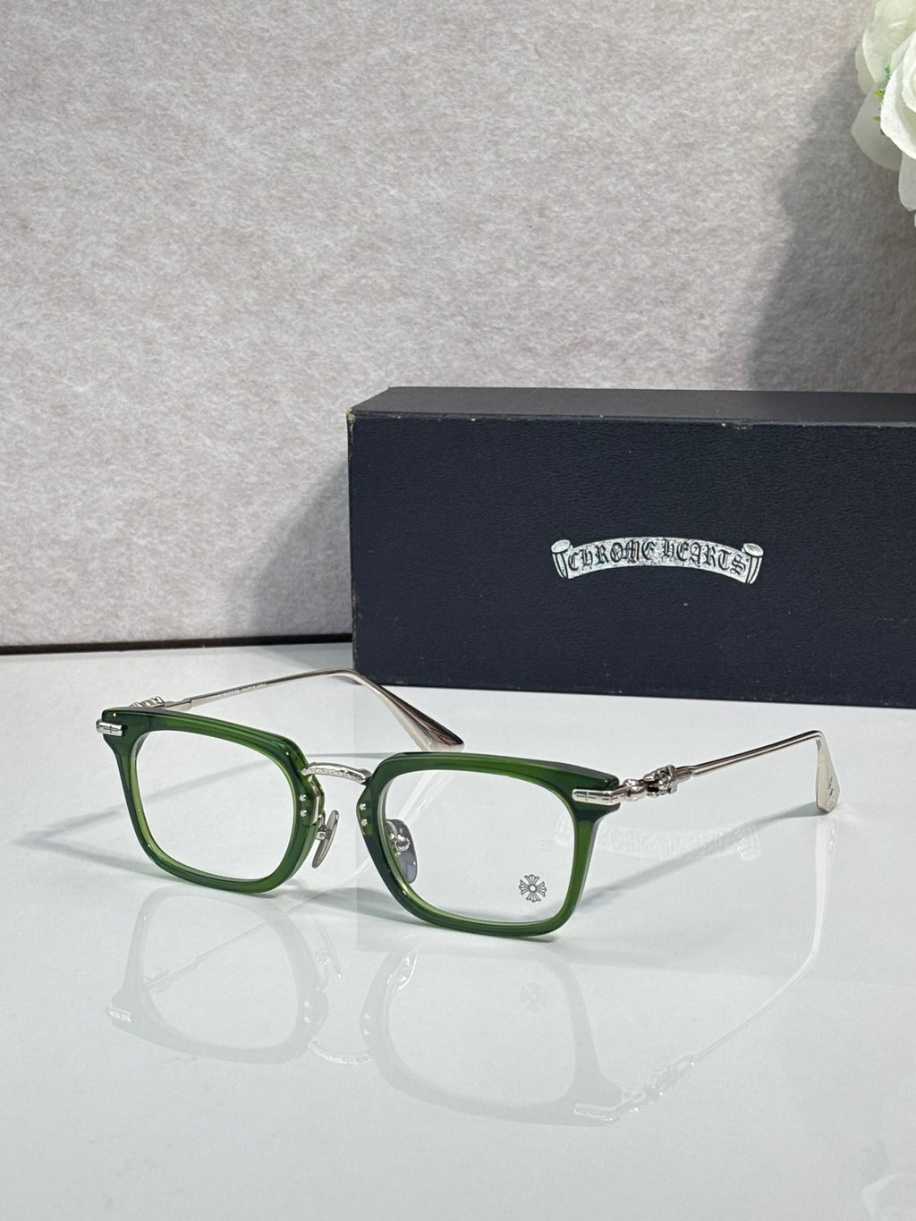 Chrome glasses with green rectangular frames and clear lenses
