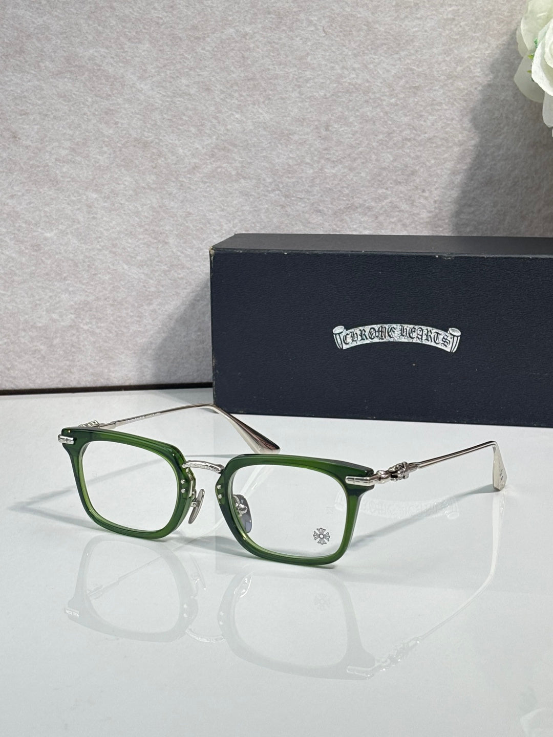 Chrome glasses with green rectangular frames and clear lenses