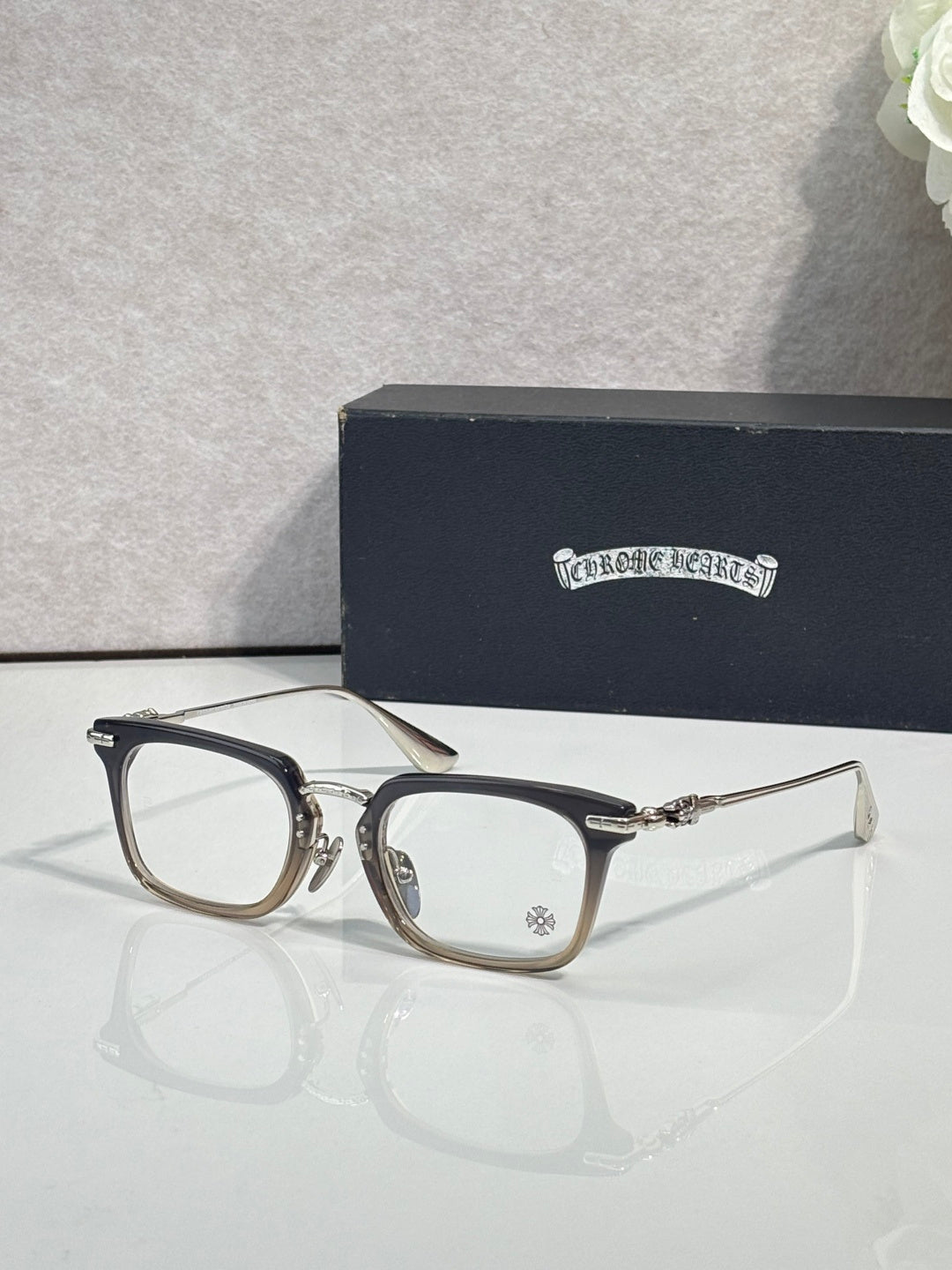 Chrome glasses with black rectangular frames and clear lenses, front view