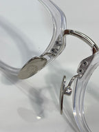 Chrome glasses close-up of clear frame temple and metal hinges