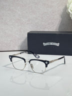 Eyeglasses with dark frame, clear lenses, gold temple arms with star pattern
