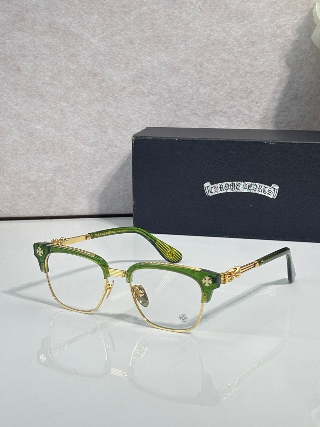 Eyeglasses with green frame, clear lenses, gold temple arms with star motif
