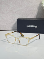 Eyeglasses with light tortoise frame, clear lenses, gold arms with ornate pattern