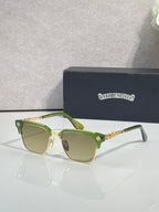 Cat-eye glasses with green frame, gold arms, and light-tinted lenses