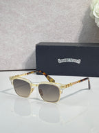 Cat-eye glasses with gold-tortoise frame, gold arms, and light-tinted lenses