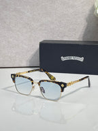 Cat-eye glasses with gold-tortoise frame, gold arms, and blue-tinted lenses