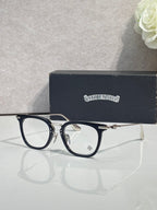 Chrome eyeglasses with dark blue frames and gold temples, clear lenses