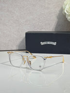 Chrome eyeglasses with light gray frames, gold temples, and clear lenses