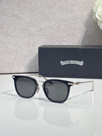 Chrome sunglasses with dark navy frames, gold-tone hinges, and tinted lenses