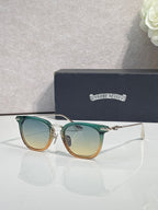 Chrome sunglasses with green-tinted frames, gold-tone accents, and tinted lenses