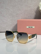 Gold-tone sunglasses with tinted lenses and green temples, bold angular design