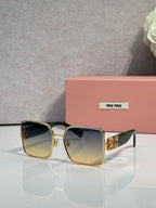 Gold square sunglasses with dark lenses and green striped temple accents