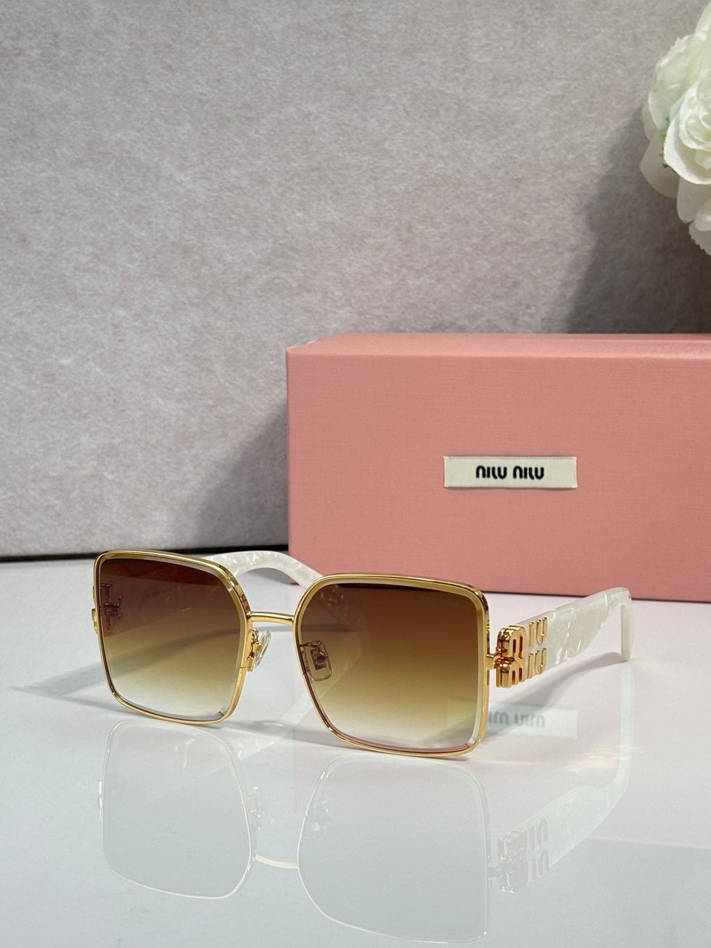 Gold square sunglasses with brown gradient lenses and gold-tone frame accents