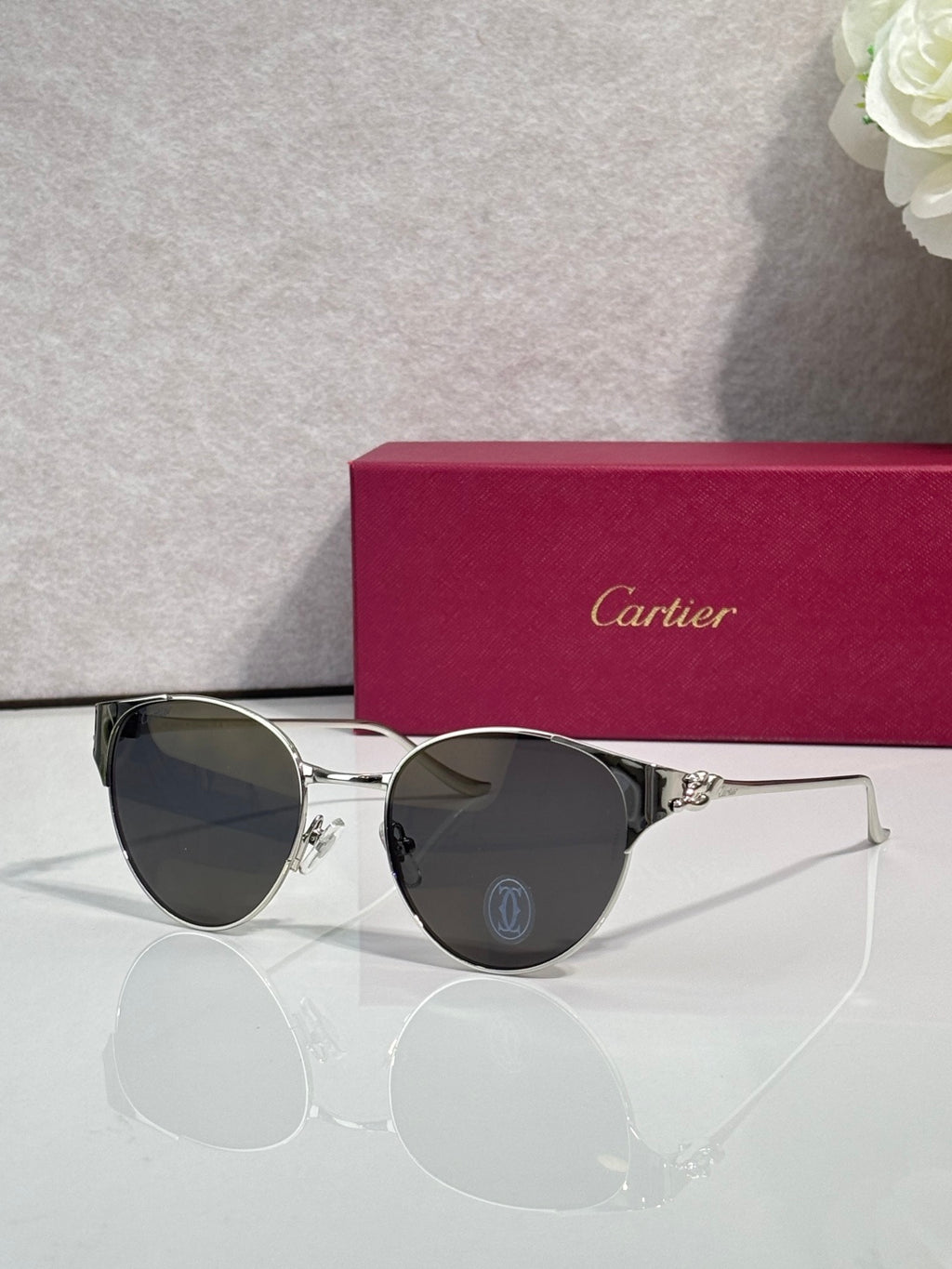 Cartier sunglasses with silver metal frame and dark round lenses