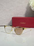 Cartier sunglasses with gold metal frame and clear tinted lenses, round shape