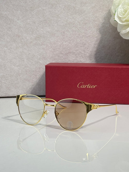 Cartier sunglasses with gold metal frame and clear tinted lenses, round shape