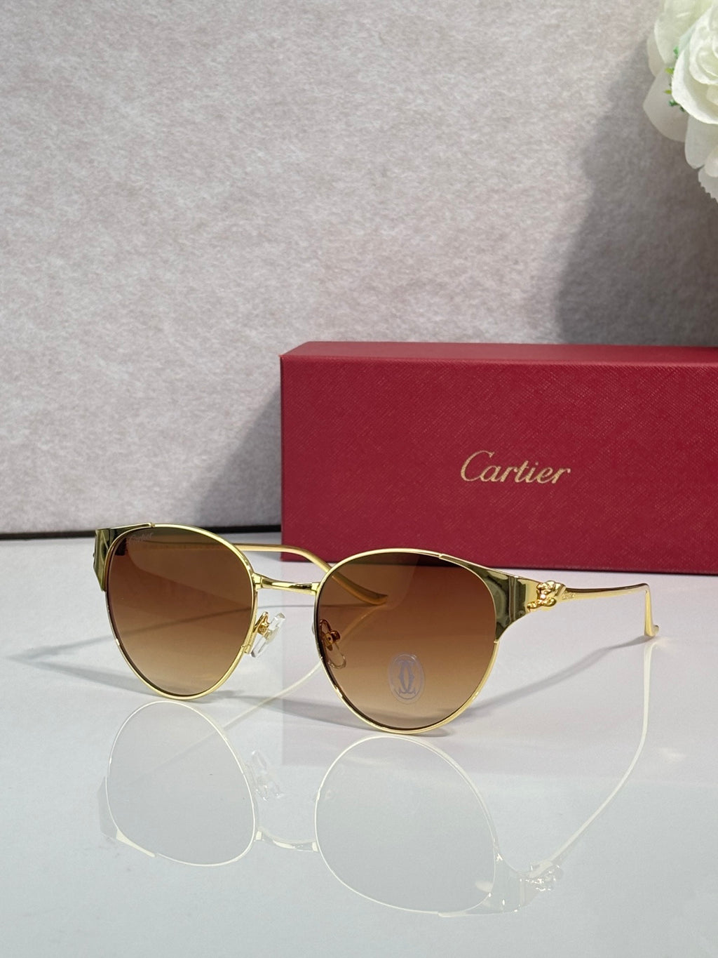 Cartier sunglasses with gold metal frame and amber tinted round lenses